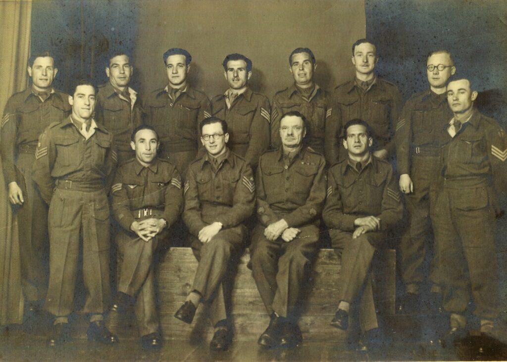 An old photo of 13 men wearing British army uniforms